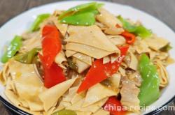 The method of stir frying chili peppers with dried tofu