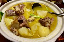 The method of stewing potato and fruit with braised pork trotters