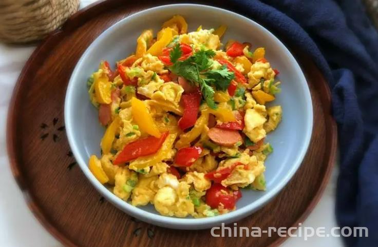 The method of stir frying eggs with colored peppers