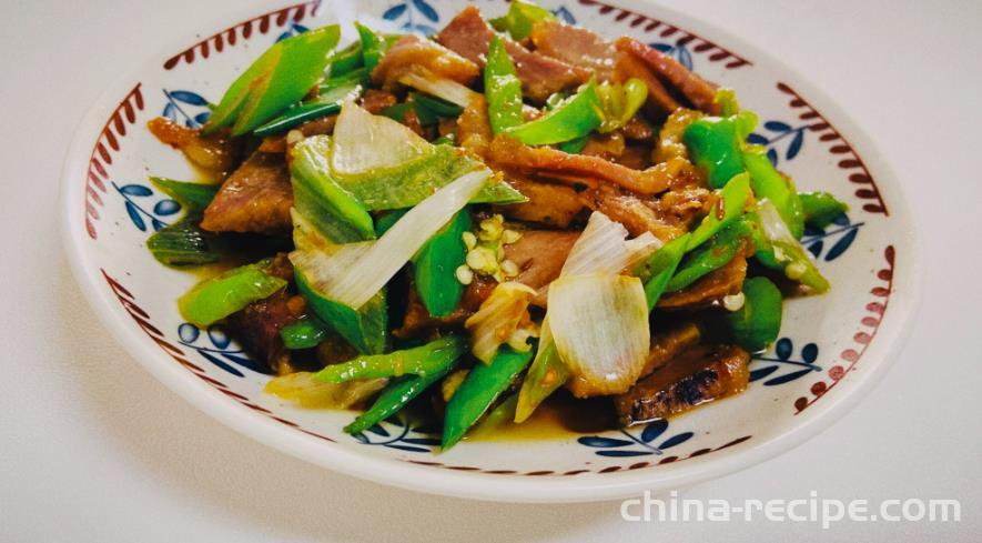 The method of stir frying pork with scallions